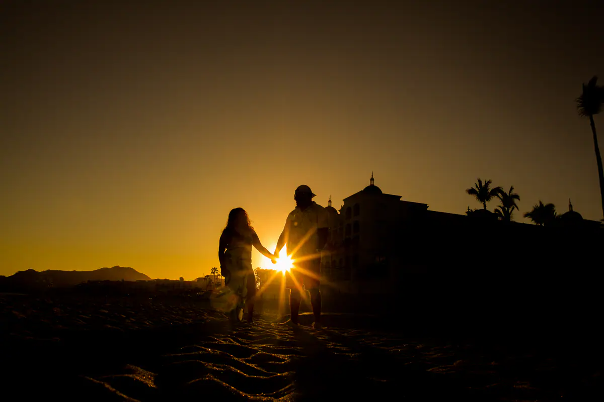 A family in silhouette against the golden sun